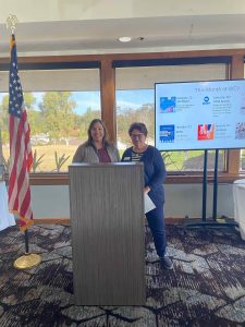 Jessica and Judy at the podium explaining Donation Day