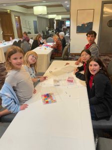 Making Swift bracelets for autism walk at WCV at night meeting