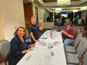 Making Swift bracelets for autism walk at WCV at night meeting