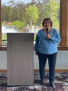 Donna at podium sharing about the Autism Walk