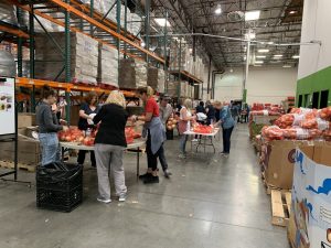 Volunteers at the produce bagging stations