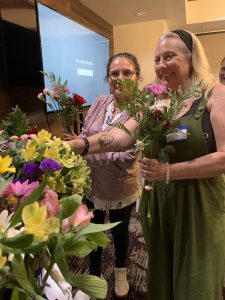 Maria and Raschel are selecting flowers for their arrangement