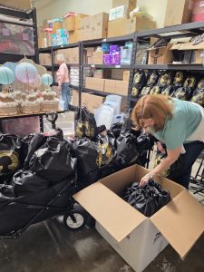 Liz looking through a box of donated items